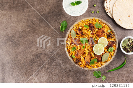 Spiced chicken masala biryani with flatbread and raita. Top view. Copy space. Indian food. 129281155