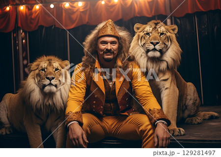 Trainer showcases incredible bond with lions and tigers during circus performance at a vibrant outdoor arena 129281497