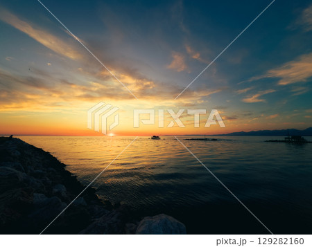 Rocks Of The Cliff Facing The Beautiful Sunset Rocks Of The Cliff Facing The Beautiful Sunset 129282160