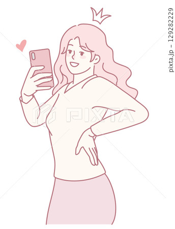 A confident young woman takes a selfie with her smartphone, showing her vibrant personality 129282229