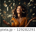 Woman in yellow shirt throwing money 129282291