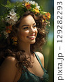 Woman adorned with spring flowers enjoys a sunny day in a lush green garden, radiating joy and tranquility 129282293