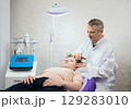 a cosmetologist doctor makes cosmetic procedures on the face of a young guy in a beauty salon 129283010