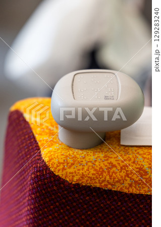Braille code printed on seat knob to assist eye sight disabled person to find their seat on public train Braille code printed on seat knob to assist eye sight disabled person to find their seat on public train 129283240