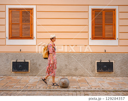 Woman Walking Through the Historic Center of Varazdin 129284357