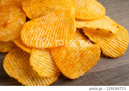 Potato chips , delicious BBQ seasoning spicy for crips, thin slice deep fried snack fast food. 129284723
