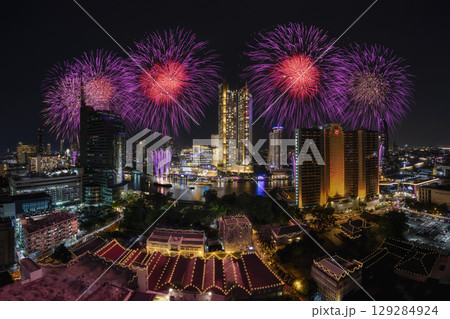 Bangkok, Thailand - December 31, 2022 : Iconsiam shopping mall buildings in the city with water reflection, firework, light show at night time. 129284924
