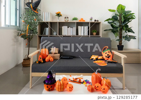 Halloween Decor. A cozy living room filled with festive decorations and pumpkins. 129285177