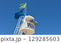 White lifeguard tower on blue sky as a background. Image suitable for beach safety, tourism 129285603