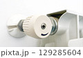 The thermostat knob on a radiator heater, adjusting the temperature 129285604