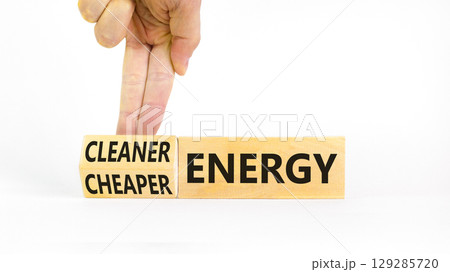 Cleaner or cheaper energy symbol. Concept words Cleaner energy Cheaper energy on beautiful wooden blocks. Beautiful white background. Business Cleaner or cheaper energy concept. Copy space. 129285720