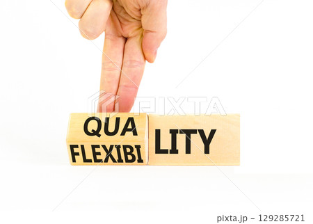 Quality or flexibility symbol. Concept words Quality Flexibility on wooden cubes. Beautiful white table white background. Businessman hand. Business and quality or flexibility concept. Copy space. 129285721