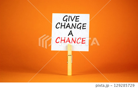 Give change a chance symbol. Concept words phrase Give change a chance on beautiful white paper on clothespin. Beautiful orange paper background. Business Give change a chance concept. Copy space. 129285729
