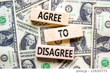 Agree to disagree symbol. Concept words Agree to disagree on beautiful wooden blocks. Dollar bills. Beautiful background from dollar bills. Business and agree to disagree concept. Copy space. Agree to disagree symbol. Concept words Agree to disagree on beautiful wooden blocks. Dollar bills. Beautiful background from dollar bills. Business and agree to disagree concept. Copy space. 129285775