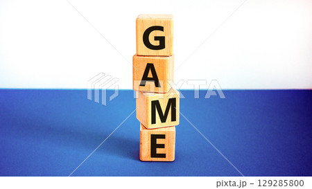 Game symbol. Concept word Game on beautiful wooden blocks. Beautiful white and blue background. Business, lifestyle and game concept. Copy space. Game symbol. Concept word Game on beautiful wooden blocks. Beautiful white and blue background. Business, lifestyle and game concept. Copy space. 129285800