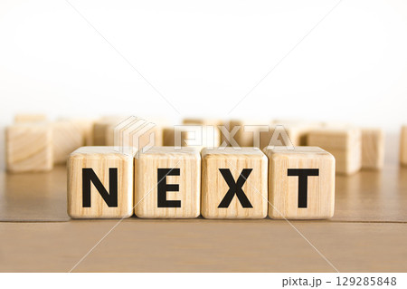 Next symbol. Concept word Next on beautiful wooden blocks. Beautiful wooden table white background. Business, lifestyle, support and next concept. Copy space. Next symbol. Concept word Next on beautiful wooden blocks. Beautiful wooden table white background. Business, lifestyle, support and next concept. Copy space. 129285848