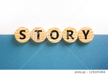 Story symbol. Concept word Story on beautiful wooden circles. Beautiful white and blue background. Business lifestyle story concept. Copy space. 129285868