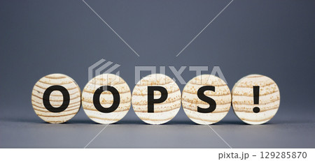 Oops symbol. Concept word Oops on beautiful wooden circles. Beautiful grey table grey background. Business lifestyle oops concept. Copy space. Oops symbol. Concept word Oops on beautiful wooden circles. Beautiful grey table grey background. Business lifestyle oops concept. Copy space. 129285870