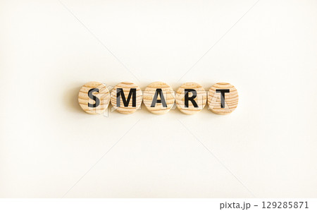 Smart symbol. Concept word Smart on beautiful wooden circles. Beautiful white table white background. Business lifestyle smart concept. Copy space. 129285871