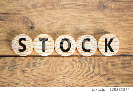 Stock symbol. Concept word Stock on beautiful wooden circles. Beautiful wooden table wooden background. Business lifestyle stock concept. Copy space. Stock symbol. Concept word Stock on beautiful wooden circles. Beautiful wooden table wooden background. Business lifestyle stock concept. Copy space. 129285874
