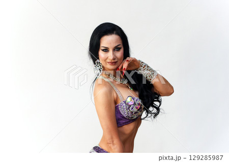 Elegant Brunette Dancer in Traditional Eastern Dance Costume Showcasing Grace and Beauty Elegant Brunette Dancer in Traditional Eastern Dance Costume Showcasing Grace and Beauty 129285987