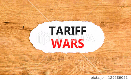 Trade tariff wars symbol. Concept word Tariff wars on beautiful white paper. Beautiful wooden paper background. Business trade tariff wars concept concept. Copy space. 129286031