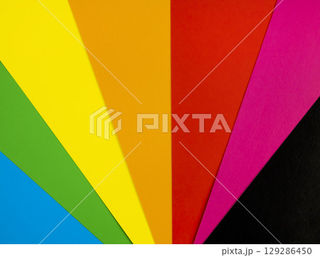 Brightly coloured sheets of paper arranged in a fan shape. A fan made of coloured paper. Brightly coloured sheets of paper arranged in a fan shape. A fan made of coloured paper. 129286450