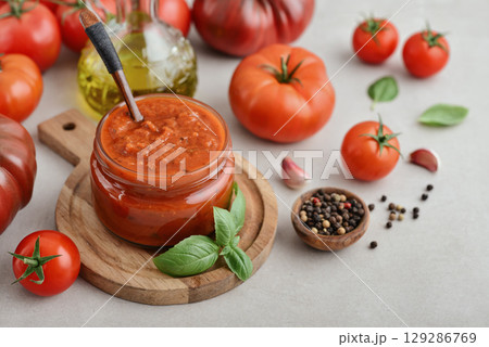 Traditional tomato sauce in a glass jar with fresh basil 129286769