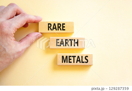 Rare earth metals symbol. Concept words Rare earth metals on beautiful wooden block. Businessman's hand. Beautiful white background. Business and rare earth metals concept. Copy space. Rare earth metals symbol. Concept words Rare earth metals on beautiful wooden block. Businessman's hand. Beautiful white background. Business and rare earth metals concept. Copy space. 129287359