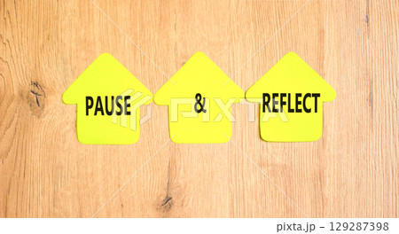 Pause and reflect symbol. Concept words Pause and reflect on beautiful yellow paper houses. Beautiful wooden background. Business motivational lifestyle pause and reflect concept. Copy space. 129287398