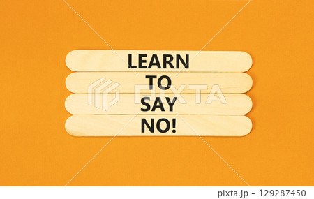 Learn to say no symbol. Concept words phrase Learn to say no on beautiful wooden stick. Beautiful orange paper background. Business psychological Learn to say no concept. Copy space. 129287450
