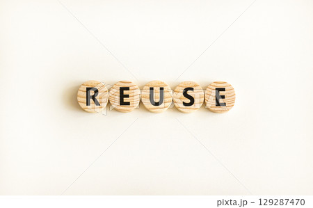 Reuse symbol. Concept word Reuse on beautiful wooden circles. Beautiful white table white background. Business lifestyle ecological reuse concept. Copy space. Reuse symbol. Concept word Reuse on beautiful wooden circles. Beautiful white table white background. Business lifestyle ecological reuse concept. Copy space. 129287470