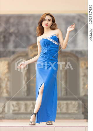 Elegant Woman in Blue Strapless Gown Posing Elegant Woman in Blue Strapless Gown Posing 129287489