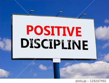 Positive discipline symbol. Concept words Positive discipline on beautiful big white billboard. Beautiful blue sky cloud background. Business psychology positive discipline concept. Copy space. 129287492