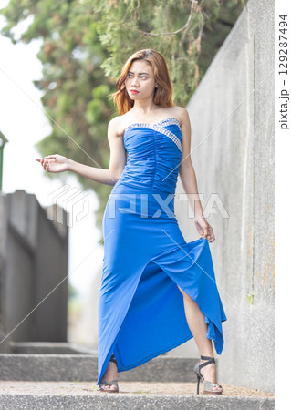 Elegant Woman in Blue Strapless Gown Posing 129287494