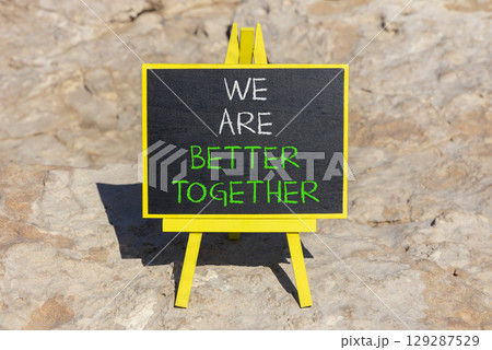 We are better together symbol. Concept words phrase We are better together on beautiful black blackboard. Beautiful stone background. Business We are better together concept. Copy space. 129287529