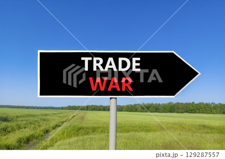 Trade war symbol. Concept word Trade war on beautiful black road sign. Beautiful green grass field blue sky background. Business trade war concept. Copy space. Trade war symbol. Concept word Trade war on beautiful black road sign. Beautiful green grass field blue sky background. Business trade war concept. Copy space. 129287557