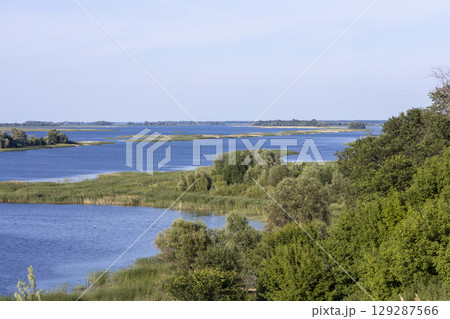 Russian landscape with Volga river on a sunny day. Bolgar, Tatarstan, Russia. View on the valley of Volga river from the hill. Peaceful nature. Beautiful background. 129287566