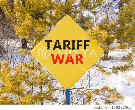 Trade tariff war symbol. Concept word Tariff war on beautiful yellow road sign. Beautiful snow winter forest background. Business trade tariff wars concept. Copy space. Trade tariff war symbol. Concept word Tariff war on beautiful yellow road sign. Beautiful snow winter forest background. Business trade tariff wars concept. Copy space. 129287569