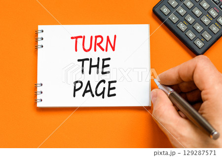 Turn the page symbol. Concept words Turn the page on beautiful white note. Beautiful orange background. Businessman hand. Business motivational lifestyle turn the page concept. Copy space. Turn the page symbol. Concept words Turn the page on beautiful white note. Beautiful orange background. Businessman hand. Business motivational lifestyle turn the page concept. Copy space. 129287571