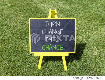 Turn change into chance symbol. Concept words phrase Turn change into chance on beautiful black blackboard. Beautiful green grass lawn background. Business Turn change into chance concept. Copy space. Turn change into chance symbol. Concept words phrase Turn change into chance on beautiful black blackboard. Beautiful green grass lawn background. Business Turn change into chance concept. Copy space. 129287606