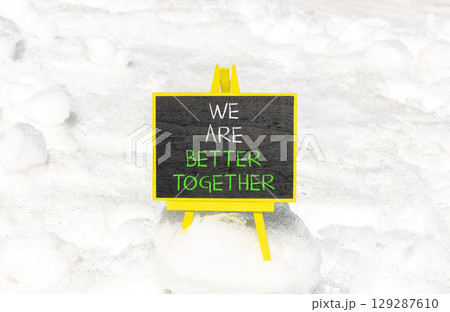 We are better together symbol. Concept words phrase We are better together on beautiful black blackboard. Beautiful white snow background. Business We are better together concept. Copy space. 129287610