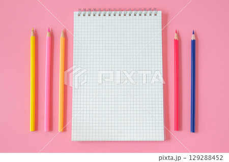Top view of notebook and color pencil on background. 129288452