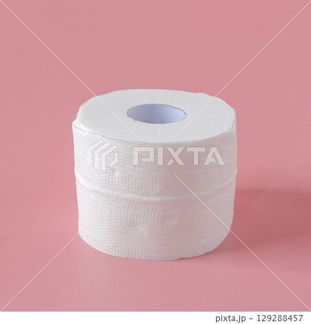 Tissue rolls of toilet paper lying on pink background. 129288457