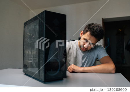 Portrait of computer repair professional gesturing toward dust-clogged air vents, highlighting potential system damage from neglected hardware cleaning and thermal buildup risks. 129288600