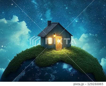 A tiny, cozy house with glowing windows sits atop a grassy hill on a small Earth, floating in a starry, celestial space. 129288865