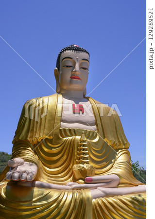 Gilded sculpture of meditating Buddha at Chua Da Bao Monastery 129289521