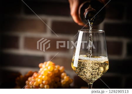 Pouring white wine 129290513