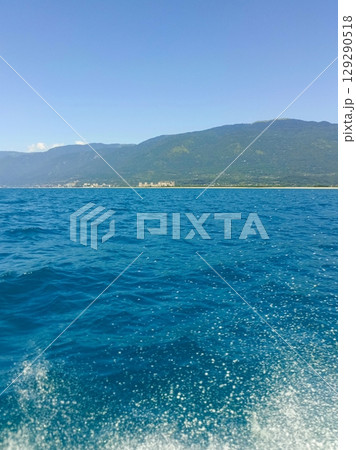 A serene seascape with distant coastline representing a peaceful voyage with copy space A serene seascape with distant coastline representing a peaceful voyage with copy space 129290518