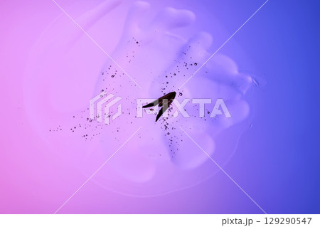 Beautiful texture of gel-like serum with a leaf on a purple background. Beautiful texture of gel-like serum with a leaf on a purple background. 129290547